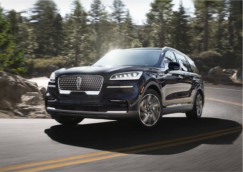 A Lincoln Aviator® SUV is being driven on a winding mountain road | Vance Lincoln in Miami OK
