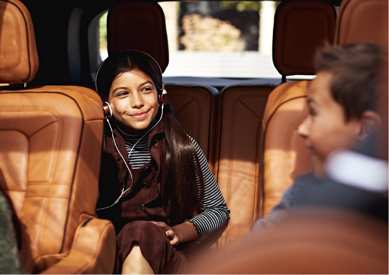 Two young people are comfortably seated in the second and third rows of a Lincoln Aviator® SUV | Vance Lincoln in Miami OK