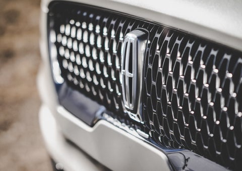 The grille of the 2024 Lincoln Aviator® Reserve model with an eye-catching repeated field of Lincoln Star logo shapes | Vance Lincoln in Miami OK
