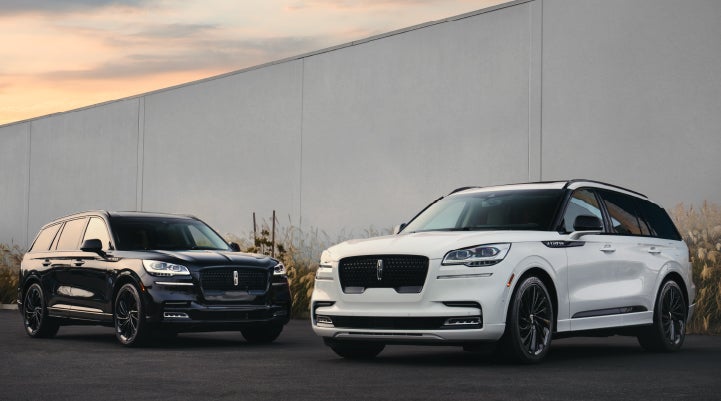 Two Lincoln Aviator® SUVs are shown with the available Jet Appearance Package | Vance Lincoln in Miami OK