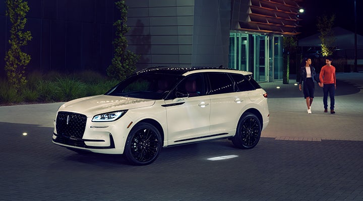 Two people approach a 2024 Lincoln Corsair® SUV featuring the available Jet Appearance Package. | Vance Lincoln in Miami OK