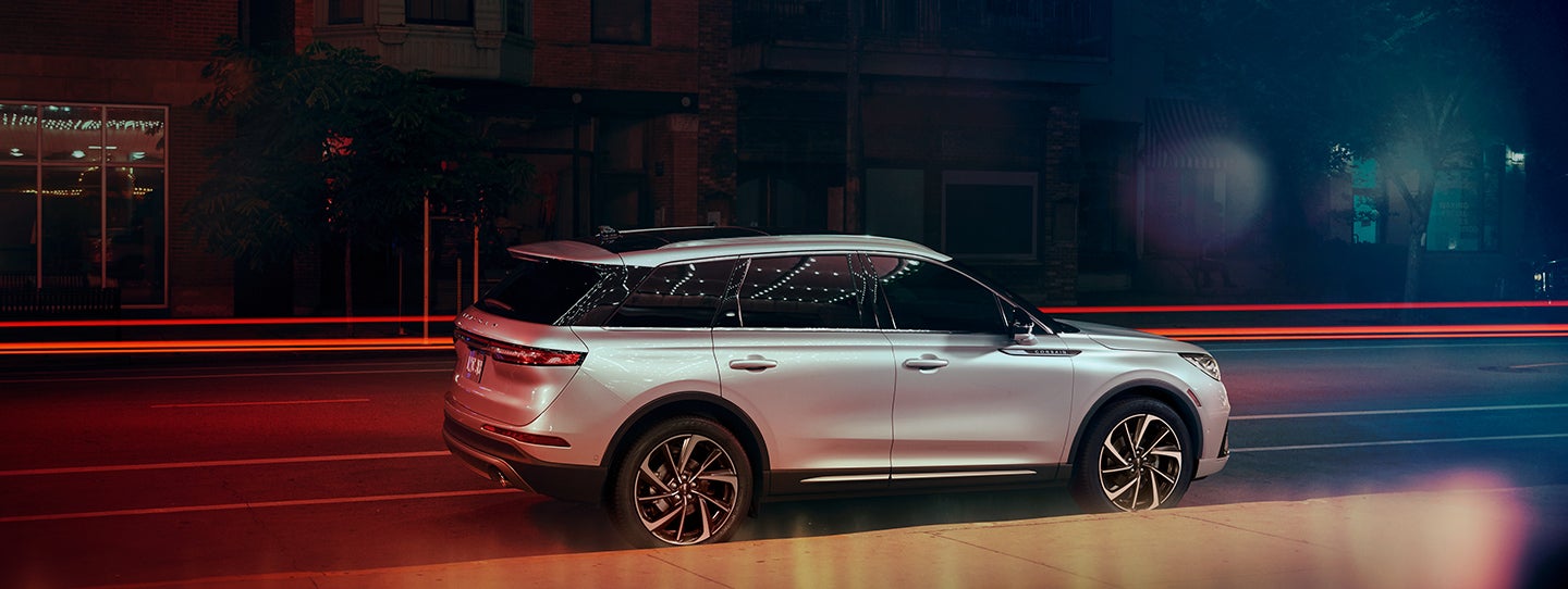 The 2024 Lincoln Corsair® SUV is parked on a city street at night. | Vance Lincoln in Miami OK