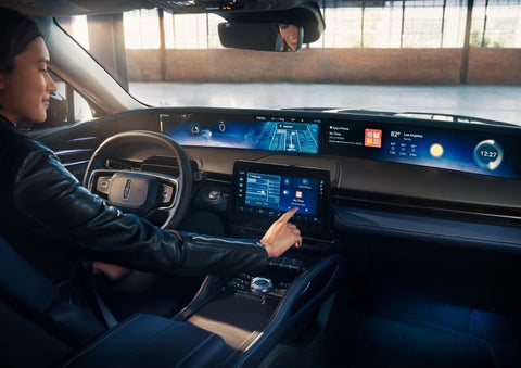 The driver of a 2024 Lincoln Nautilus® SUV interacts with the center touchscreen. | Vance Lincoln in Miami OK