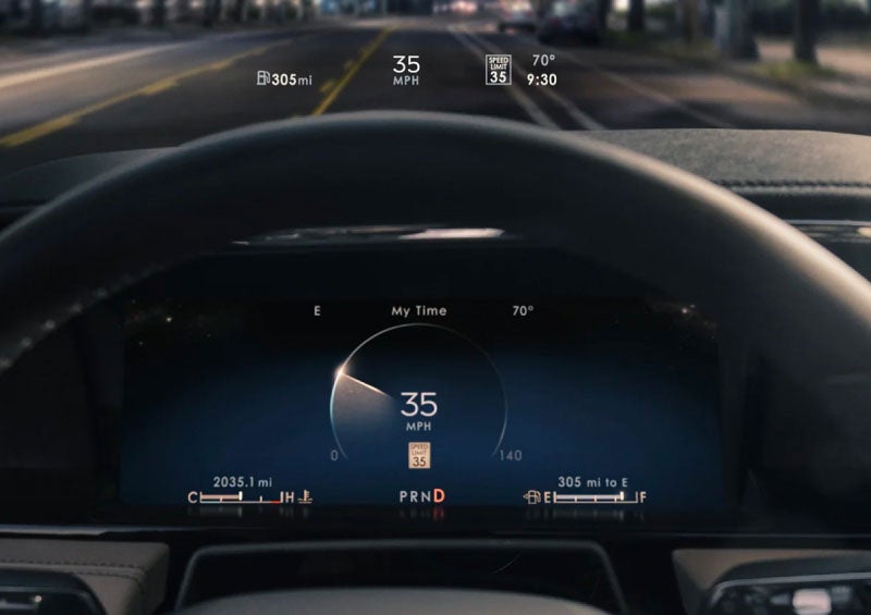 The head-up display projects driver information above the steering wheel at night.