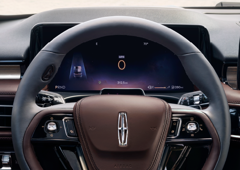 The steering wheel of 2025 Lincoln Aviator® SUV is shown with black and brown accents. | Vance Lincoln in Miami OK
