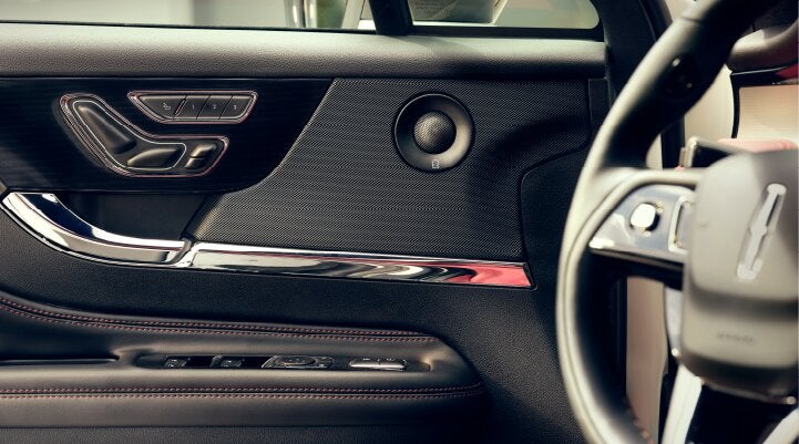 A Revel® audio speaker is shown in the driver's side door of a 2025 Lincoln Corsair® SUV. | Vance Lincoln in Miami OK