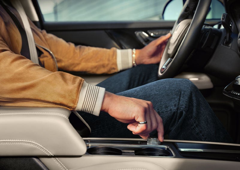 The driver of a 2024 Lincoln Corsair® SUV is shown selecting the drive mode. | Vance Lincoln in Miami OK