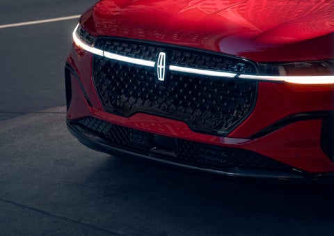 The available front LED light bar and center Lincoln Star logo glow at dusk. | Vance Lincoln in Miami OK