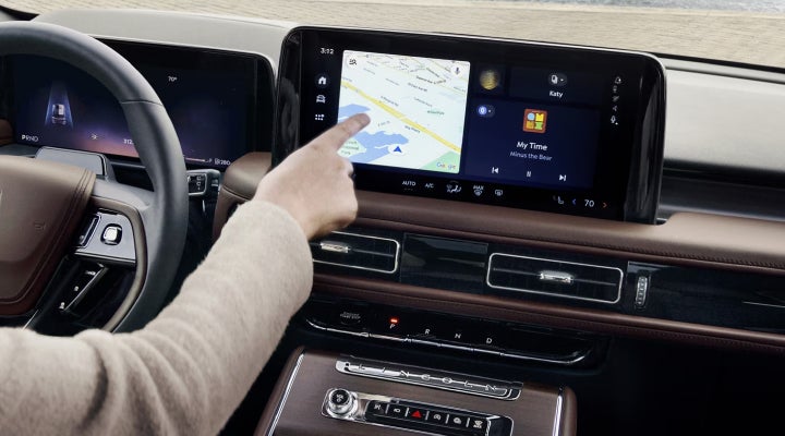 A person is tapping the center display touchscreen of a 2026 Lincoln Aviator® SUV. | Vance Lincoln in Miami OK