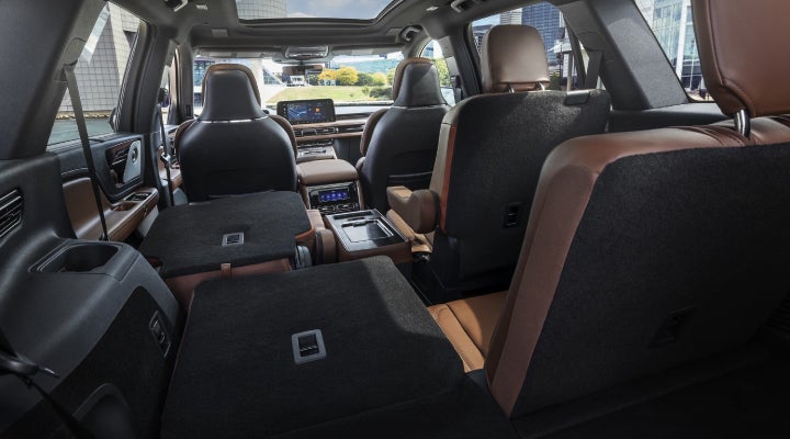 One side of the PowerFold® third-row seat and a second-row seat are folded forward in the 2026 Lincoln Aviator® SUV. | Vance Lincoln in Miami OK