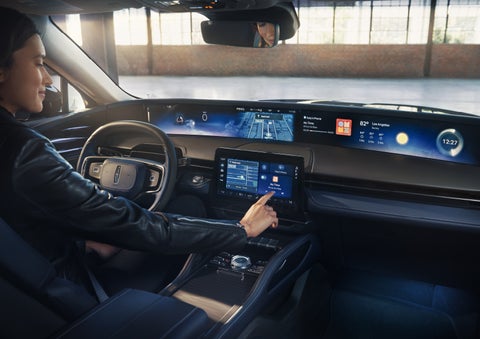 The driver of a 2026 Lincoln Nautilus® SUV interacts with the center touchscreen. | Vance Lincoln in Miami OK