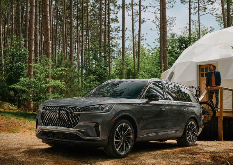A 2027 Lincoln Aviator® is parked next to a high end glamping site. | Vance Lincoln in Miami OK