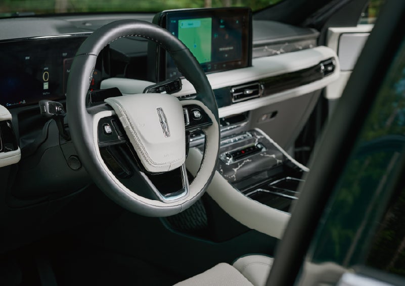 The leather-trimmed steering wheel of a 2027 Lincoln Aviator® Black Label™ SUV. | Vance Lincoln in Miami OK