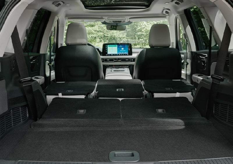 A rear to front view of the interior of a 2027 Lincoln Aviator® Black Label™ SUV shows the third and second rows folded flat | Vance Lincoln in Miami OK