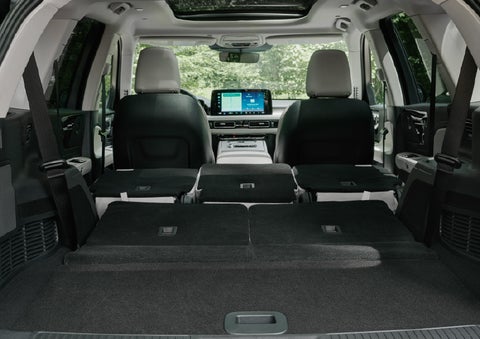 A rear to front view of the interior of a 2027 Lincoln Aviator® Black Label™ SUV shows the third and second rows folded flat | Vance Lincoln in Miami OK