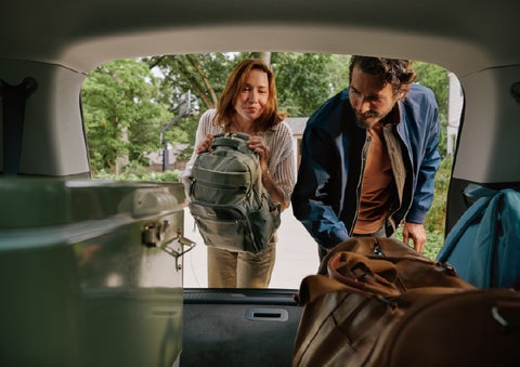 A couple loads luggage into the rear of a 2027 Lincoln Aviator® Black Label™ SUV..e 202 | Vance Lincoln in Miami OK