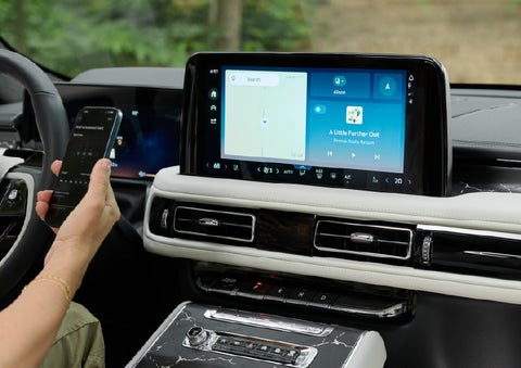 A person pairs thier phone with the center touchscreen of a 2027 Lincoln Aviator® Black Label™ SUV | Vance Lincoln in Miami OK